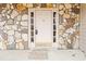 Front door with stone surround and glass panels at 2765 Hunters Pond Ln, Snellville, GA 30078