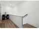 Upstairs hallway with stairs and built-in shelving at 3219 Bartee Walk, Suwanee, GA 30024