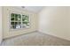 Simple bedroom with carpet, large window, and neutral walls at 2331 Suwanee Pointe Dr, Lawrenceville, GA 30043