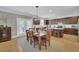 Bright dining room features a wooden table and chairs, hardwood floors, and access to the kitchen at 242 Edinburgh Ln, Woodstock, GA 30188