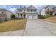 Two-story house with a two-car garage and landscaped yard at 242 Edinburgh Ln, Woodstock, GA 30188