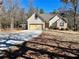 House exterior featuring a two-car garage and landscaped yard at 75 Briar Patch Rd, Covington, GA 30014