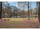 Serene backyard with pond, trees, and fallen leaves at 4211 Burnt Hickory Nw Rd, Marietta, GA 30064