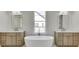 Elegant bathroom with double sinks and a freestanding bathtub at 522 Hope Hollow Ln, Loganville, GA 30052