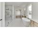Spa-like bathroom with soaking tub and glass shower at 522 Hope Hollow Ln, Loganville, GA 30052