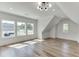 Spacious bonus room featuring hardwood floors and large windows at 522 Hope Hollow Ln, Loganville, GA 30052