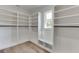 Bright walk-in closet with ample shelving and hanging space at 522 Hope Hollow Ln, Loganville, GA 30052