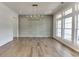 Formal dining room with hardwood floors, wainscoting, and a large chandelier at 522 Hope Hollow Ln, Loganville, GA 30052