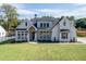 Modern farmhouse style home with large windows and a lush lawn at 522 Hope Hollow Ln, Loganville, GA 30052