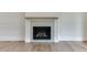 Elegant fireplace with a light gray tile surround and a wood mantel at 522 Hope Hollow Ln, Loganville, GA 30052