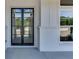 Modern black metal framed glass front door at 522 Hope Hollow Ln, Loganville, GA 30052