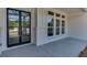 Front porch with black metal framed glass front door and white brick columns at 522 Hope Hollow Ln, Loganville, GA 30052