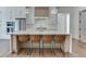 Bright kitchen with white cabinets, quartz countertops, and an island with seating at 522 Hope Hollow Ln, Loganville, GA 30052