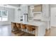 Modern kitchen features white cabinetry, quartz countertops, and a large island at 522 Hope Hollow Ln, Loganville, GA 30052