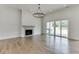 Spacious living room with hardwood floors, fireplace, and sliding glass doors to patio at 522 Hope Hollow Ln, Loganville, GA 30052