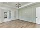 Elegant main bedroom with hardwood floors, an accent wall, and double doors at 522 Hope Hollow Ln, Loganville, GA 30052