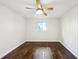 Spacious bedroom with hardwood floors and ceiling fan at 9171 Eves Cir, Roswell, GA 30076