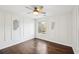 Bedroom with hardwood floors, window, and ceiling fan at 9171 Eves Cir, Roswell, GA 30076