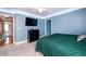 Light blue bedroom with a green comforter and a dresser at 260 Shadowbrooke Dr, Loganville, GA 30052