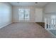 Living area with plush carpet and stairs leading to the second floor at 4635 Garden Hills Dr, Stone Mountain, GA 30083