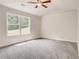 Spacious bedroom with large window and grey carpet at 40 Eryn Ter, Covington, GA 30014