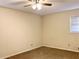 Simple bedroom with ceiling fan and large window at 2027 Kensington High St, Lilburn, GA 30047