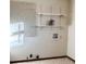 Laundry room with pegboard and shelving at 2027 Kensington High St, Lilburn, GA 30047