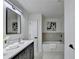 Modern bathroom with double vanity, bathtub, and gray tile at 430 Thomas Jefferson Dr, Stone Mountain, GA 30083