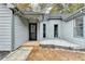 Front door entrance with gray siding and white rock landscaping at 430 Thomas Jefferson Dr, Stone Mountain, GA 30083