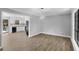 Dining room with hardwood floors, modern chandelier, and open kitchen at 6967 Cedar Dr, Riverdale, GA 30296