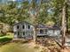 Gray house with white shutters, two-car garage, and deck at 6967 Cedar Dr, Riverdale, GA 30296