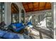 Relaxing screened porch with wood ceiling, wicker furniture, and large windows at 7860 Wentworth Dr, Duluth, GA 30097