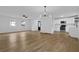 Open-concept living room and kitchen with wood-look flooring at 9148 Homewood Dr, Riverdale, GA 30274