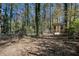 Partially wooded backyard with chain link fence at 134 Mill Ct, Dallas, GA 30157