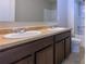 Bathroom with double sinks, granite countertop, and dark brown cabinets at 218 Princeton Ct, Acworth, GA 30102