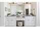 Double vanity bathroom with granite countertops and white cabinets at 404 Monarch Lake Dr, Canton, GA 30115