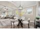 Modern glass dining table with four white chairs, located near the kitchen at 7058 Lakeview Ln, Peachtree Corners, GA 30360