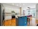 Modern kitchen with white cabinets, granite counters, and a blue island at 309 Creekbank Se Way, Smyrna, GA 30082
