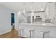 Modern white kitchen with stainless steel appliances and breakfast bar at 856 Saint Charles Ne Ave # 1, Atlanta, GA 30306