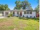 Charming white ranch-style home with a covered front porch and red door at 5425 Westford Cir, Atlanta, GA 30349