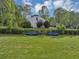 Spacious backyard with lush lawn and blue benches at 1151 Ruby Nelson Ct, Lawrenceville, GA 30043