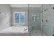 Spa-like bathroom with soaking tub, walk-in shower, and window at 1151 Ruby Nelson Ct, Lawrenceville, GA 30043