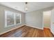 Well-lit bedroom with wood-look floors, large windows, and closet at 1151 Ruby Nelson Ct, Lawrenceville, GA 30043