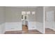 Dining room with hardwood floors, wainscoting, and access to the kitchen at 1151 Ruby Nelson Ct, Lawrenceville, GA 30043