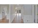 Hardwood floor hallway with white wainscoting and doors to other rooms at 1151 Ruby Nelson Ct, Lawrenceville, GA 30043