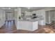 Modern kitchen with white cabinets, stainless steel appliances, and a large island at 1151 Ruby Nelson Ct, Lawrenceville, GA 30043