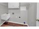 Bright laundry room with utility sink, cabinets, and shelving at 1151 Ruby Nelson Ct, Lawrenceville, GA 30043