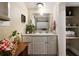 Small bathroom with white cabinets and linen closet at 1404 Cassville Nw Rd, Cartersville, GA 30121