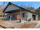 Gray renovated building with a covered carport and large wooden doors at 1404 Cassville Nw Rd, Cartersville, GA 30121