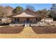 Charming ranch home with a spacious front porch and well-manicured landscaping at 1404 Cassville Nw Rd, Cartersville, GA 30121